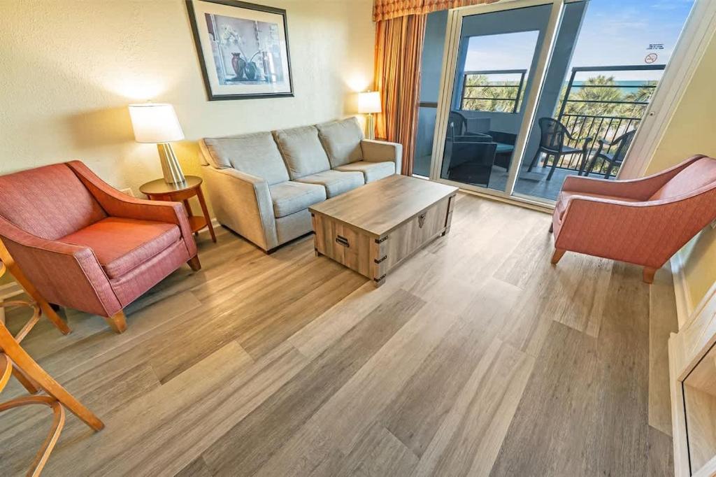 a living room with a couch and chairs and a table at 2BR Pools, Direct Oceanfront Views, Handicap, Nice in Myrtle Beach