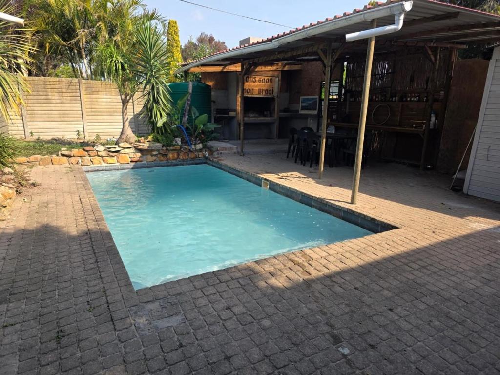 a swimming pool in a yard with a house at CLR-Accommodation in George