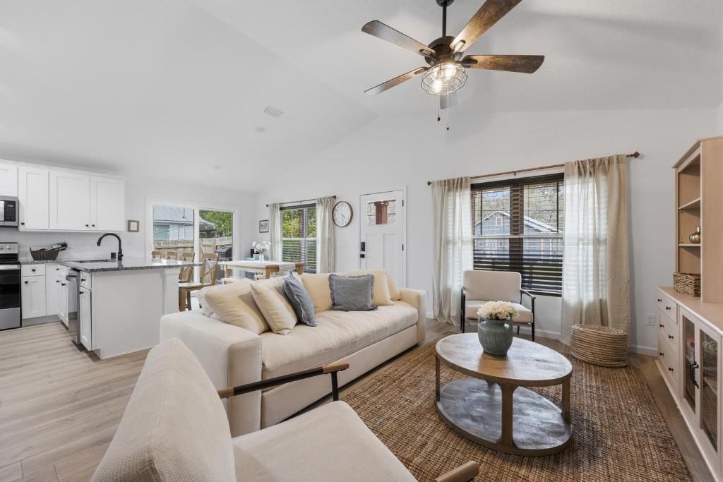 a living room with a couch and a table at Cozy Coastal Cottage Minutes to Beach and Downtown in St. Augustine