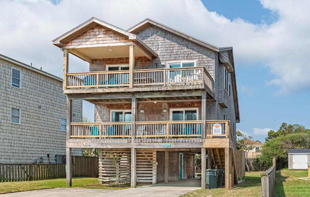 a house with a wrap around deck at Seagrove View - NH MP 10.5, Oceanside, 800 ft to the BEACH, YMCA Passes in Nags Head