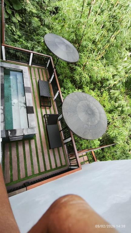 a person is looking at a model of a house at Baruna Sari Villa yoga and reatret view jungle in Ubud