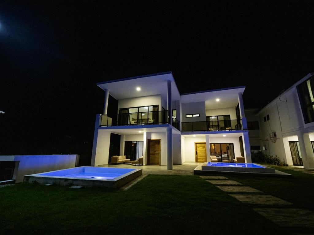 a large house at night with a swimming pool at Ocean View-picuzzi Villa RI duplex Las Galeras in Piedra de La Ballena
