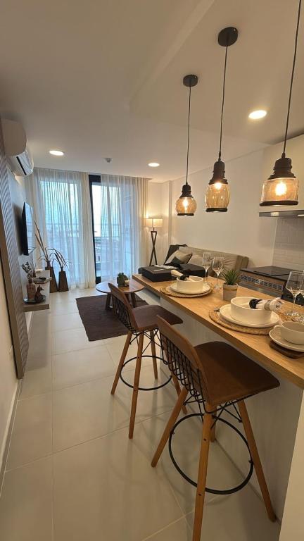 a kitchen with a table and chairs in a room at LUXER VIVO Encarnacion in Encarnación