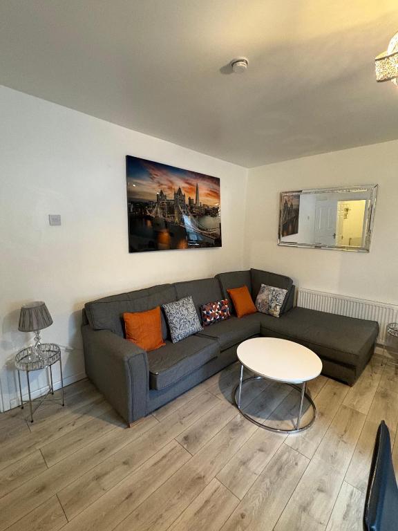 a living room with a couch and a table at Elegance apartments in West Cornforth
