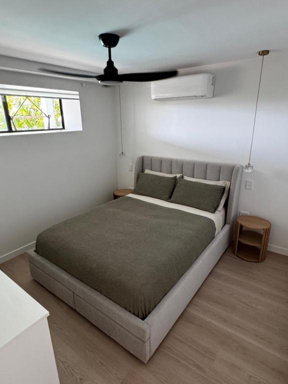 a bedroom with a bed in a white room at Luxury self-contained guest suite in Gold Coast