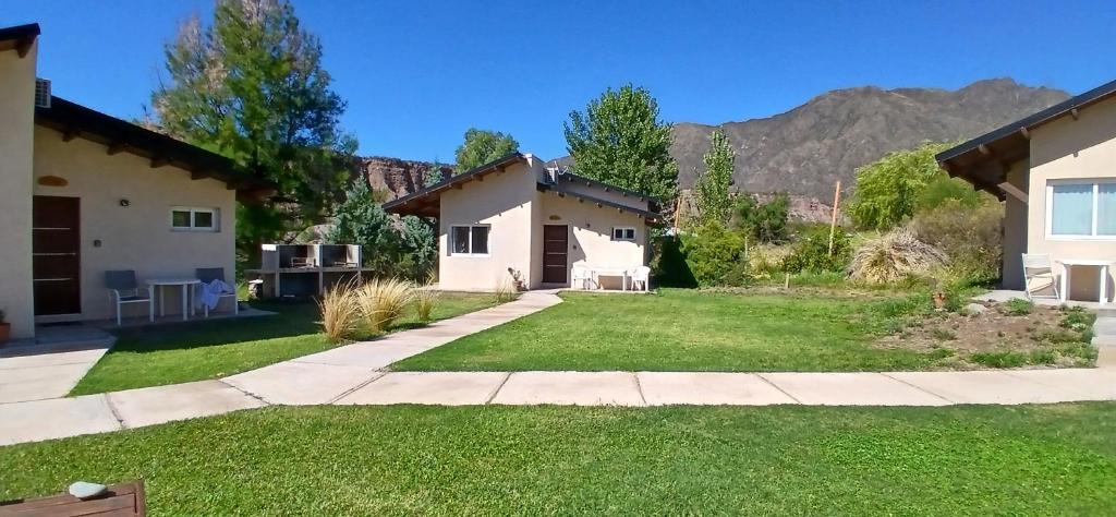 a backyard of a house with a lawn at Starry Lodge in Ciudad Lujan de Cuyo