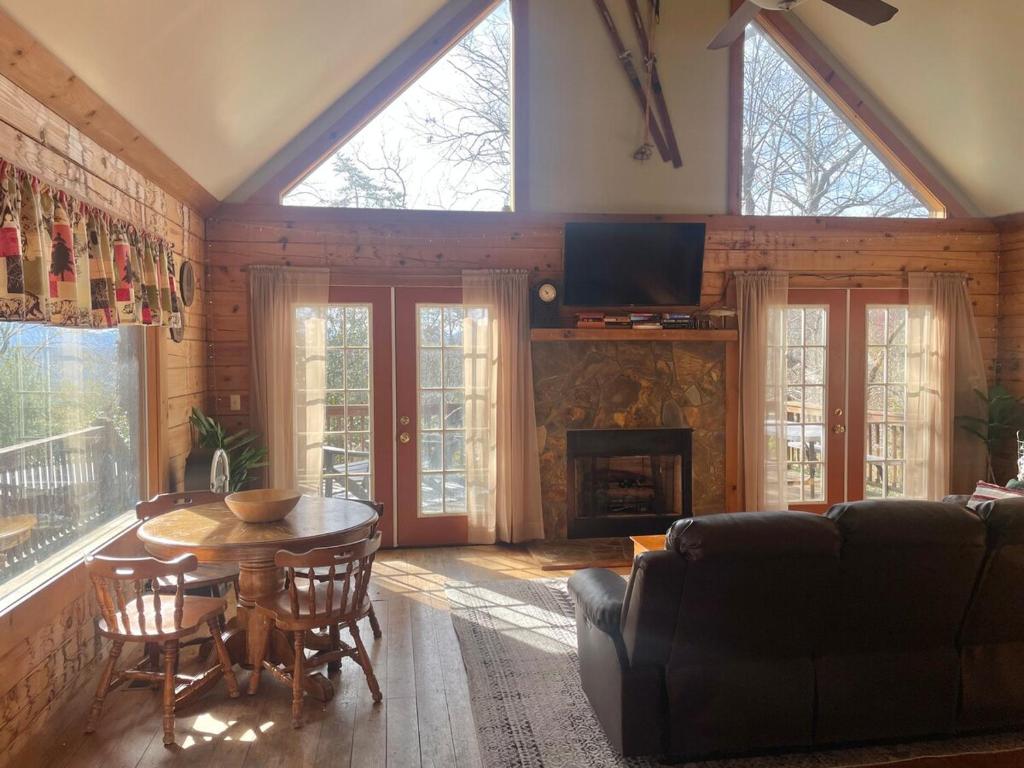 a living room with a table and a couch at Turkey Ridge Retreat in Bryson City