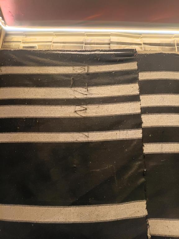 a black and white mattress with white stripes on it at Rum Towers Luxury Camp in Aqaba