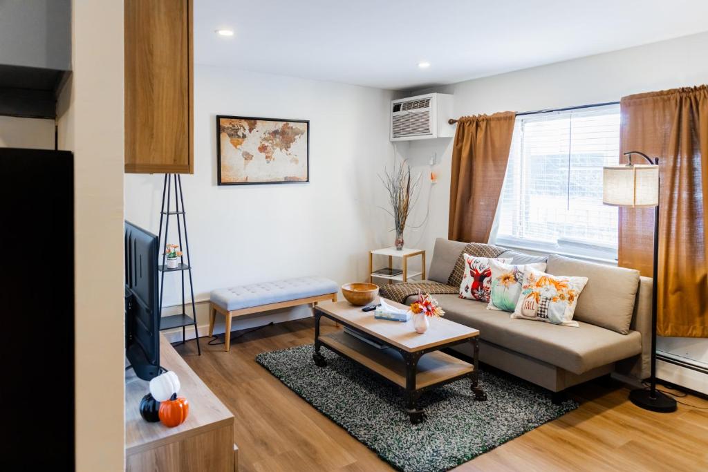a living room with a couch and a table at Spacious 2-Bedroom Apartment NYC-10 mins away in Union City