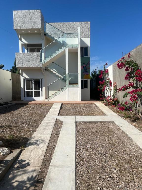 a house with a walkway in front of it at Bungalows Anton in San Blas