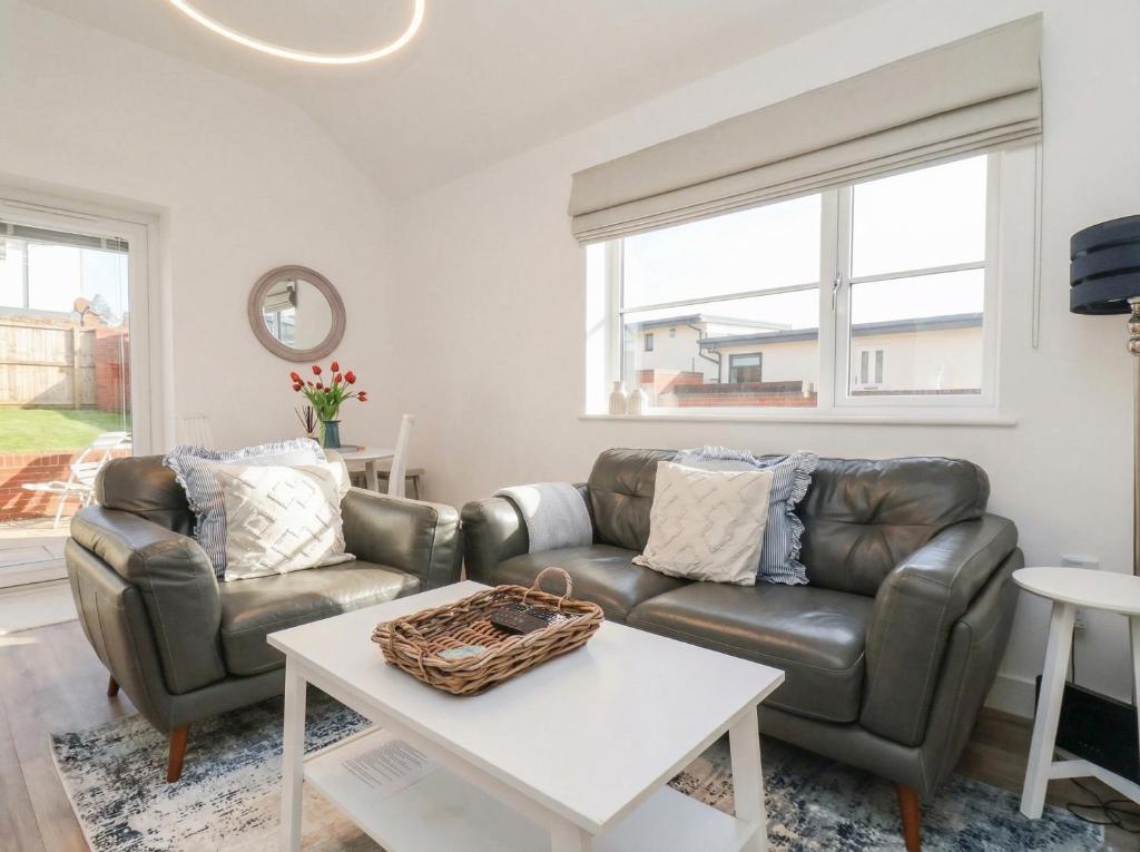 a living room with two couches and a table at The Nest in Bridlington