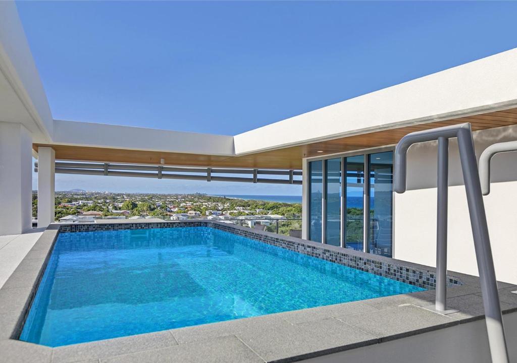 a swimming pool on the roof of a house at Bokarina Beachfront Penthouse - Oceanfront Luxury with Exclusive Rooftop Pool & Steam Room in Bokarina