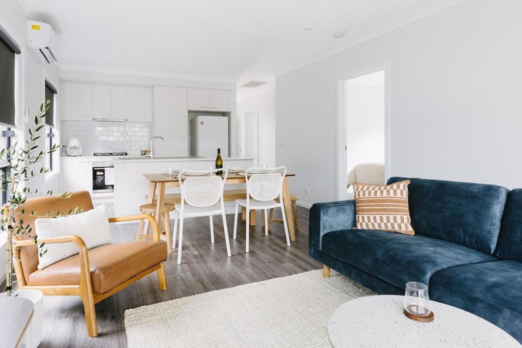 a living room with a blue couch and a table at King Bed, 3 Beds, 2 bath, Sleeps 6 in Sale