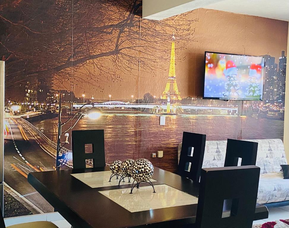 a dining room with a view of the eiffel tower at Luxury Penthouse in Tuxpan