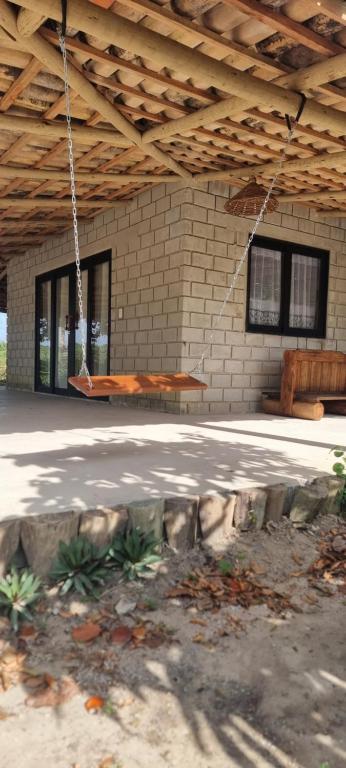 a building with a wooden bench hanging from a ceiling at Casa de pedra in Prado