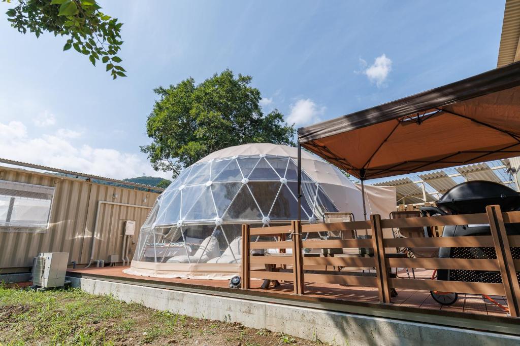 a domed building with a glass dome on a patio at Morethan Paradise in Nagatoro