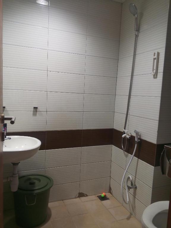 a bathroom with a shower and a sink and a toilet at Wanti Kost in Depok