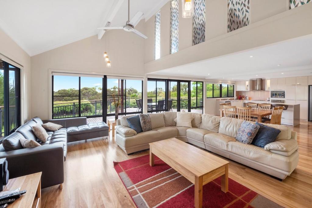 a living room with a couch and a table at Sea Forth on Otter in Quindalup