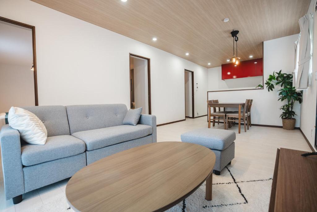 a living room with a couch and a table at Value Residence Hotel 久貝 in Miyako-jima