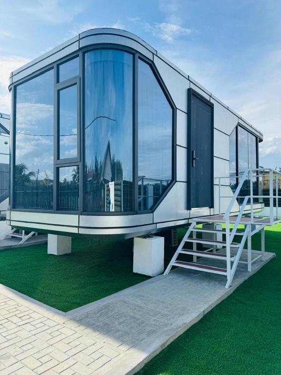 a building with large glass windows and a staircase at Coolhomtel in Semporna