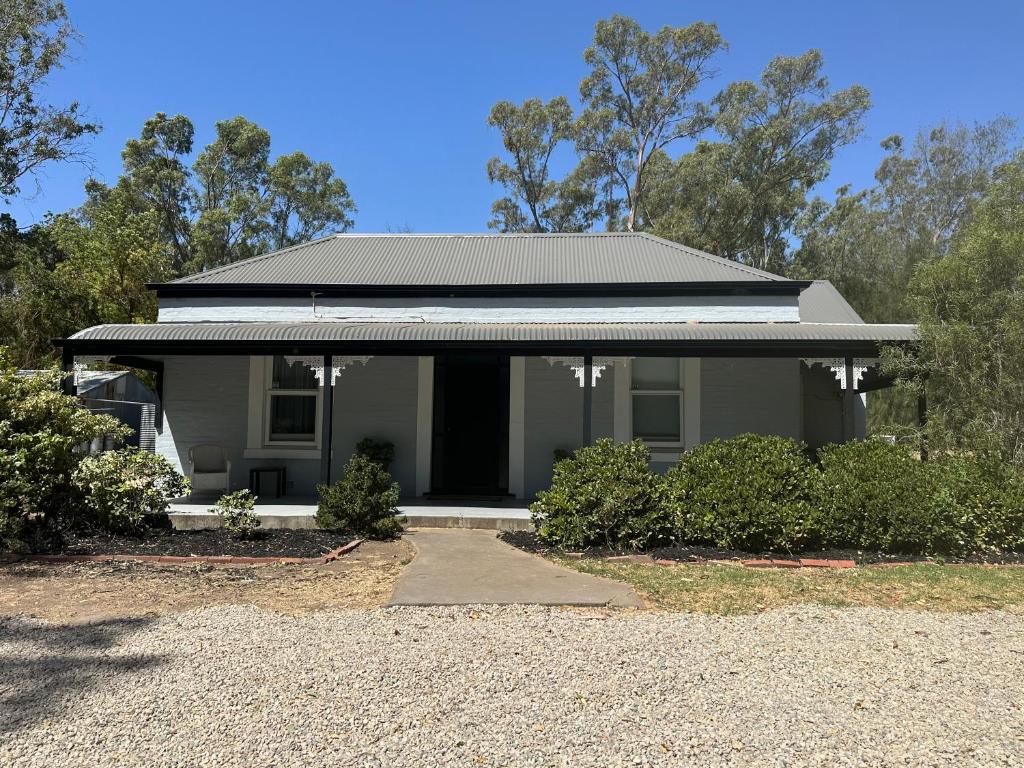 a grey house with a black roof and bushes at Clare Cottage on Wendouree in Clare