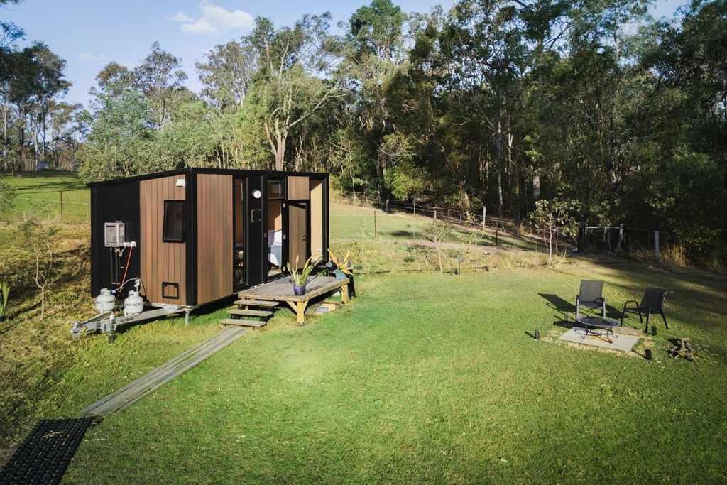 a tiny house in the middle of a field at The Mini Chalet by Tiny Away in Bromfleet