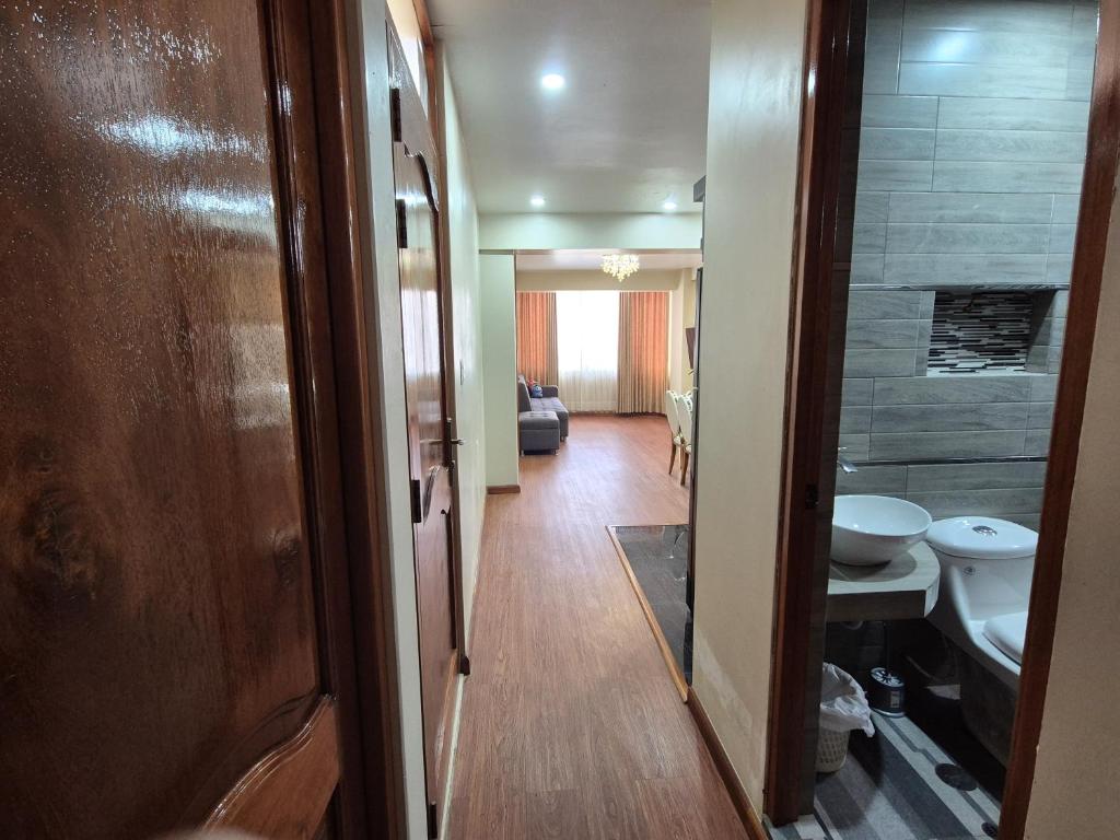a hallway with a toilet and a sink in a room at Marito in Juliaca