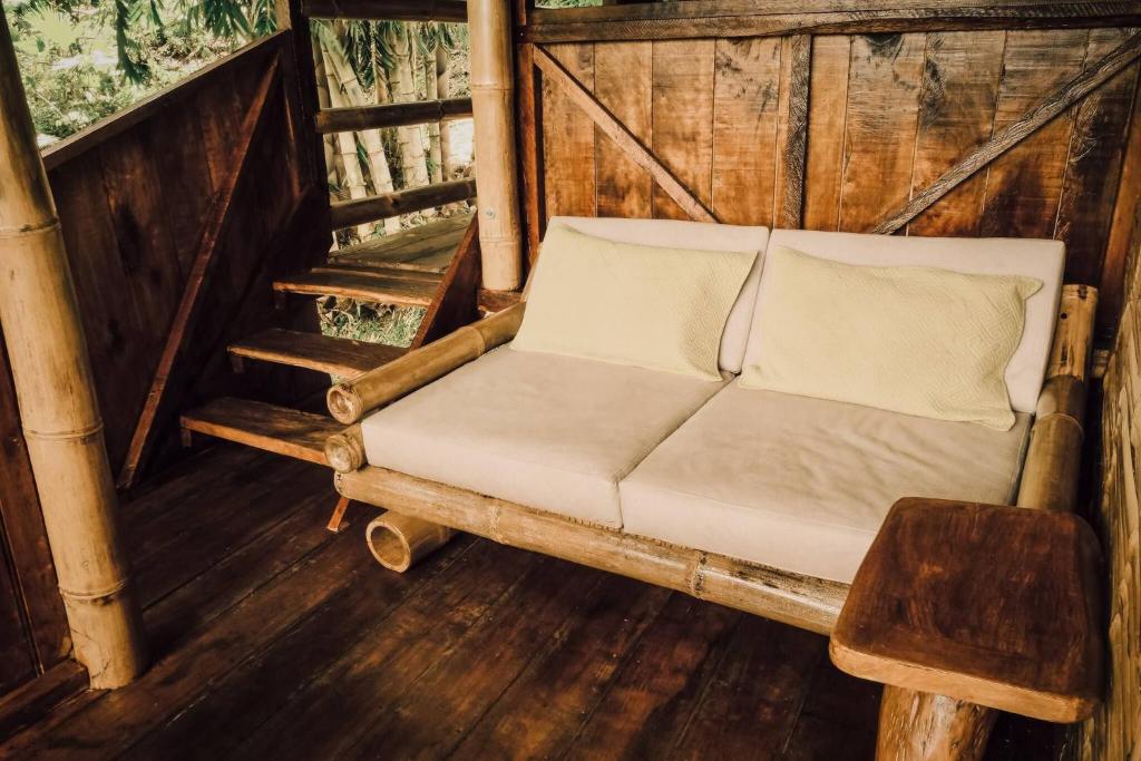 a couch sitting in the middle of a room at Toucan Lodge Amazon Rainforest Retreat in Tarqui