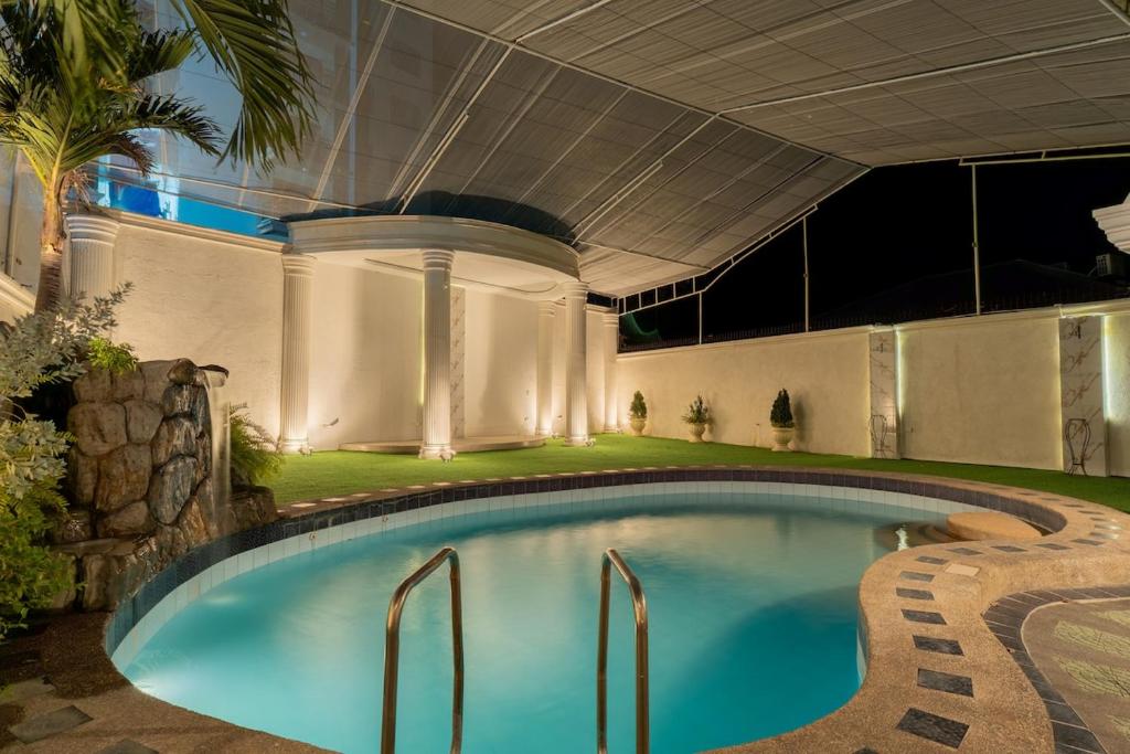 a swimming pool in the middle of a building at White House, Billiard, Private Pool, Prime Location in Angeles