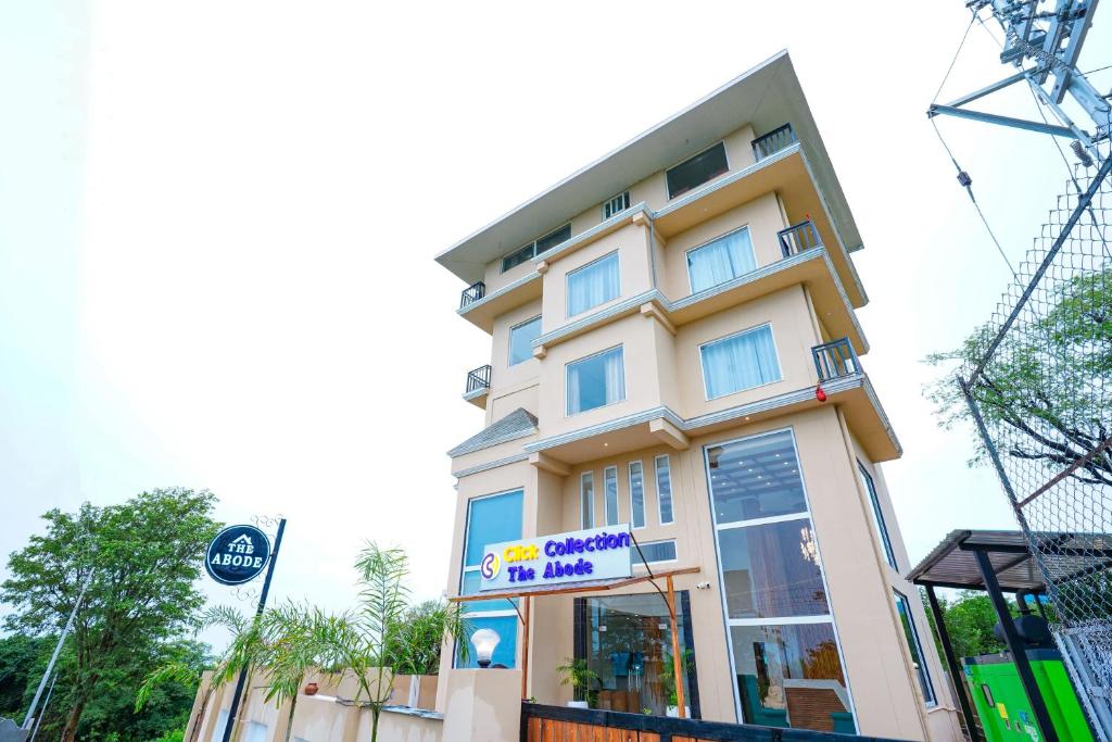 a building with a sign in front of it at Click Collection The Abode Dharamshala in Dharamshala