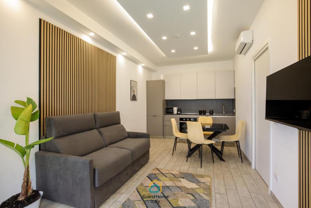 a living room with a couch and a table at Coho House Fiumicino in Fiumicino