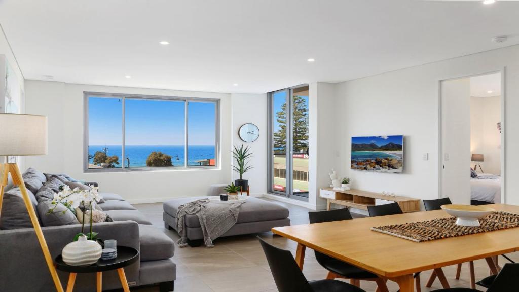 a living room with a couch and a table at Oceans Edge #7 Accom Holidays in Terrigal