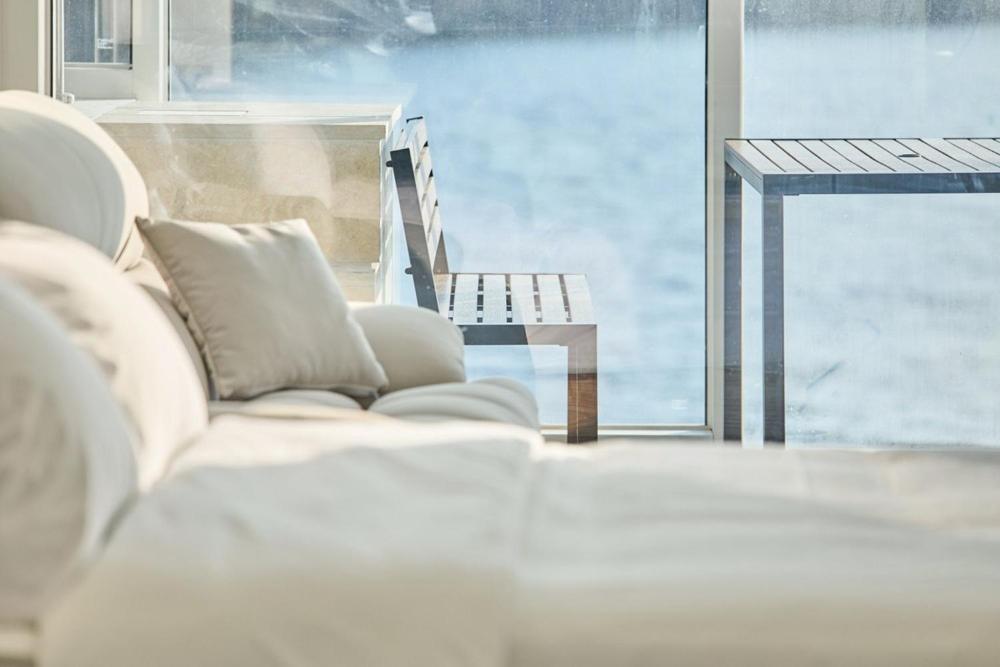 a living room with a white couch and a window at Geoje The Shine Pool Villa in Geoje