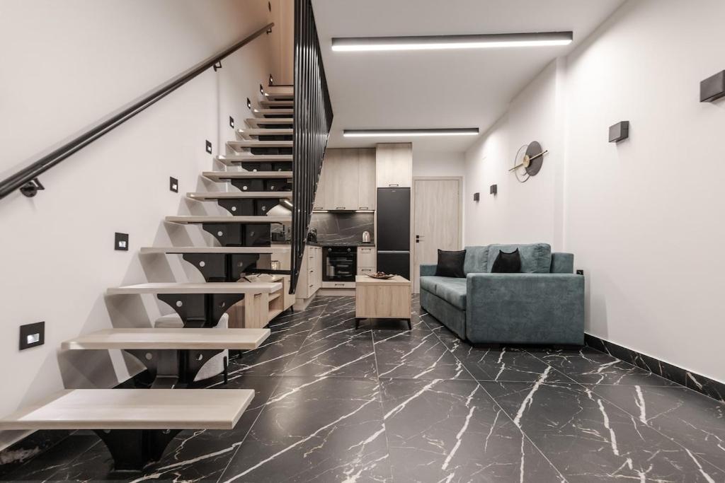 a living room with a staircase and a couch at Signature Luxury Loft in Volos