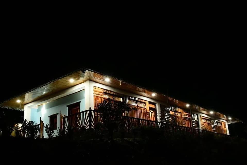 a house lit up at night with lights on it at Bungbakha Homestay in Singtām