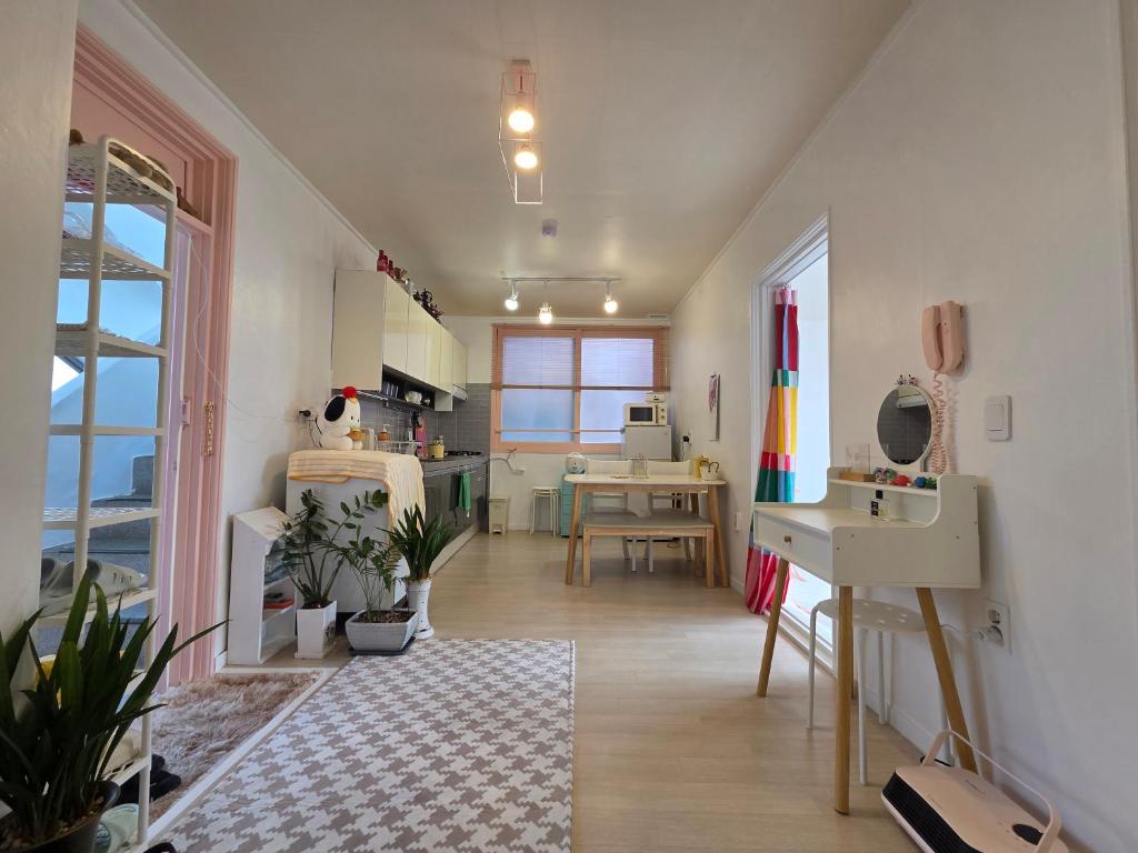 a large room with a kitchen and a dining room at 케이앞산 하우스 in Daegu