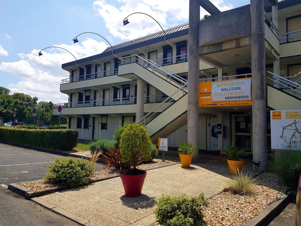 a building with a stairway in front of it at Première Classe Chateauroux - Saint Maur in Saint-Maur