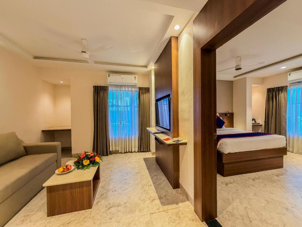 a hotel room with a bed and a couch at Zip by Spree Hotels Shirdi - Walkable Distance from Sai Baba Temple in Shirdi