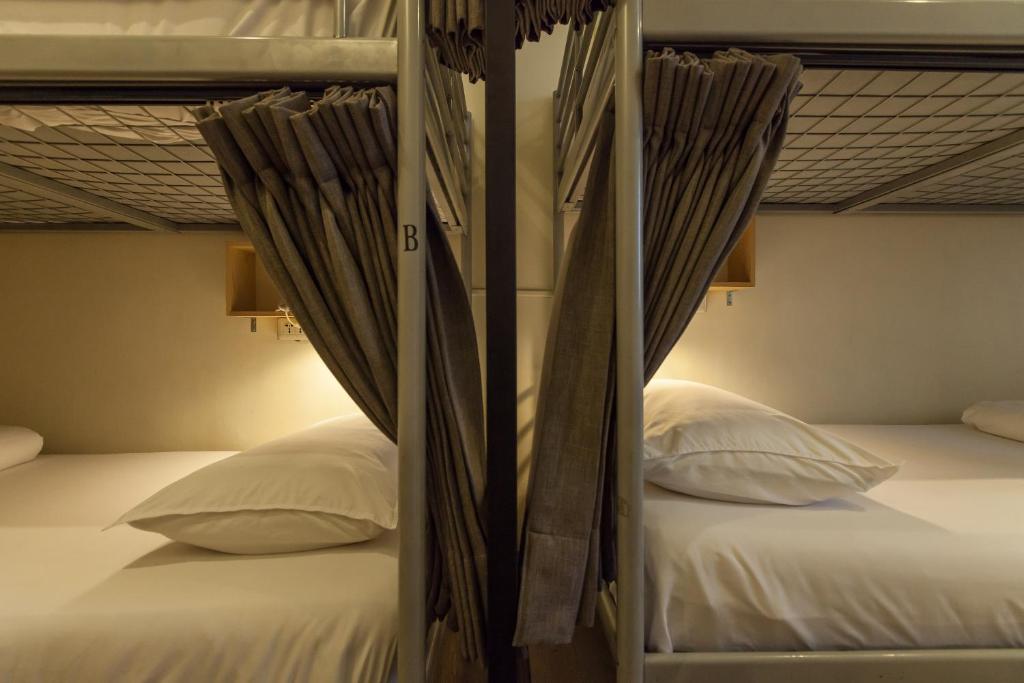 two beds in a room with two bunk beds at Sleeping Boot Hostel in Hualien City