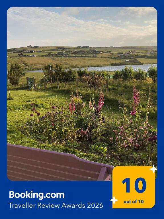 a view of a garden with flowers in a field at Old School B&B Super King Exclusive 5 Room private suite in Orkney