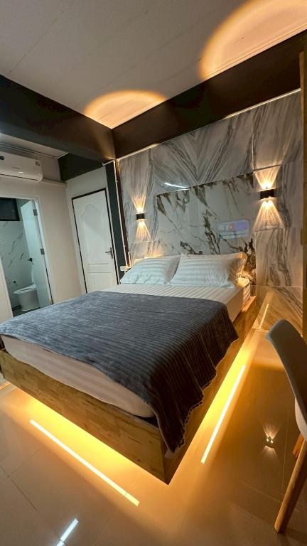 a bedroom with a large bed with lights on it at Villa Moon Terrace in Bang Khen