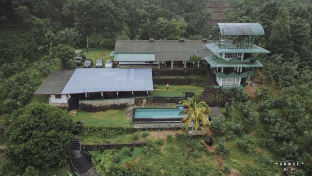 an aerial view of a house with a yard at Gilbys Eco Bungalow in Udaweliwitiya