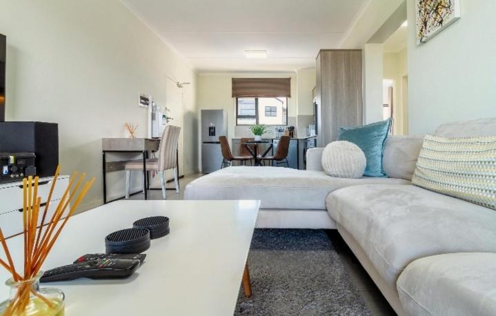 a living room with a couch and a table at AlimamaSpaces The Lavender in Northriding