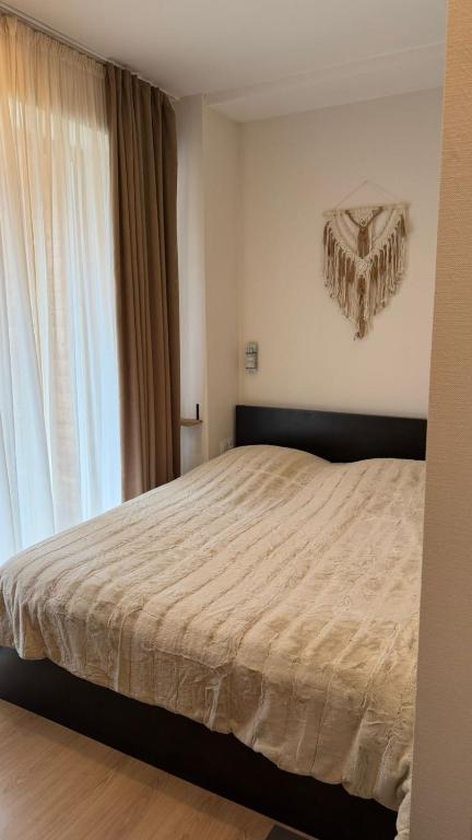 a bedroom with a large bed and a window at Bakuriani valley Didveli in Bakuriani