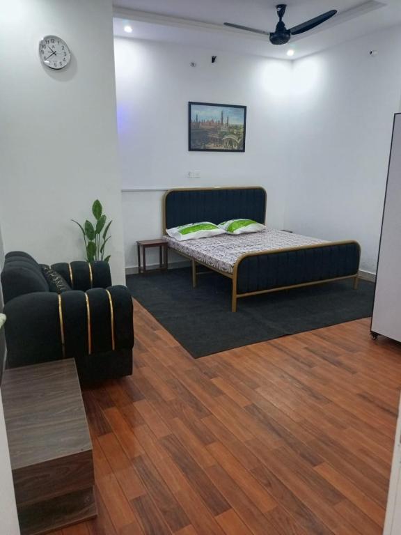 a living room with a bed and a couch at BIA RESIDENCEs in Sāhīwāl