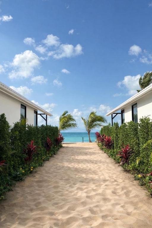 a pathway to the beach with houses and the ocean at Sea Escapes Villas in Thong Sala