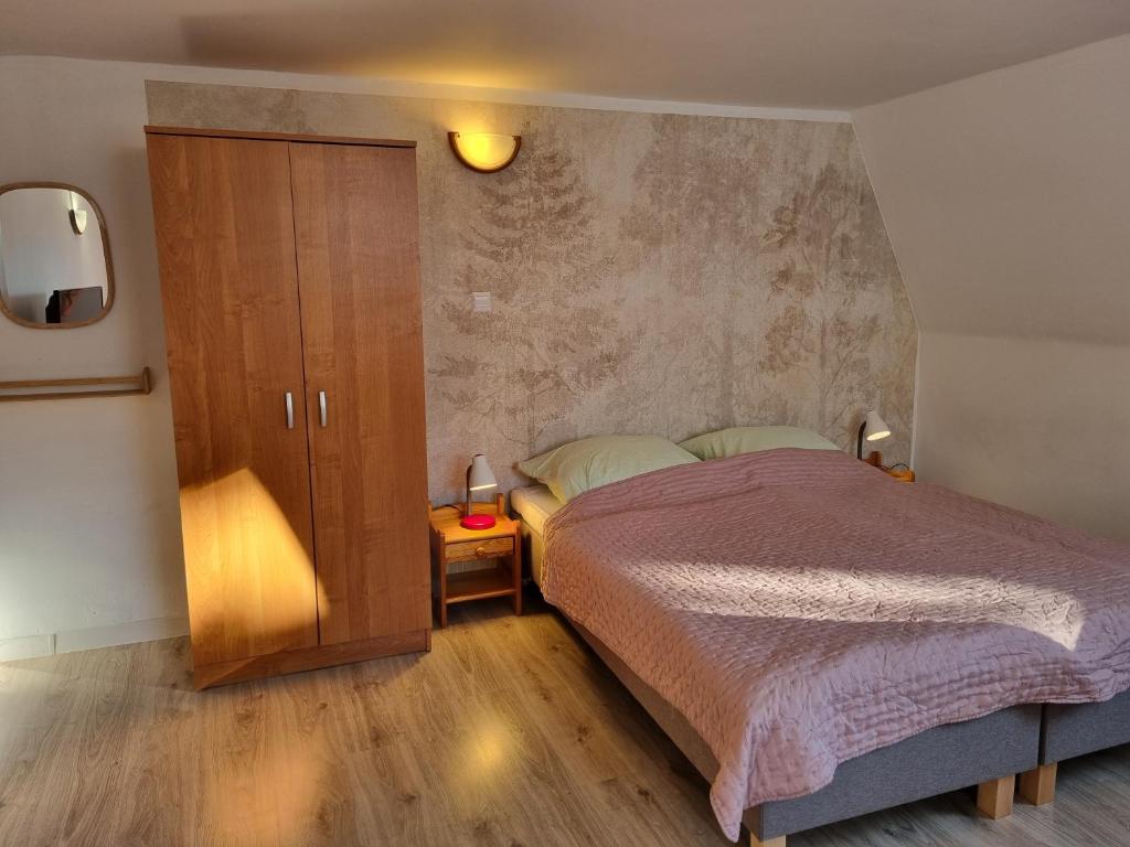 a bedroom with a bed and a cupboard and a bed sidx sidx at Sielanka pod Siglanami 2 in Wisła