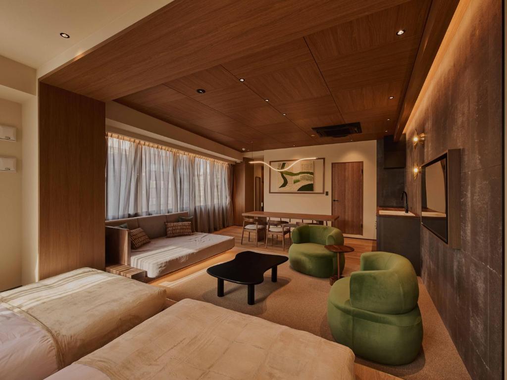 a bedroom with a bed and a living room at illi Aest Shinagawa-Gotanda in Tokyo