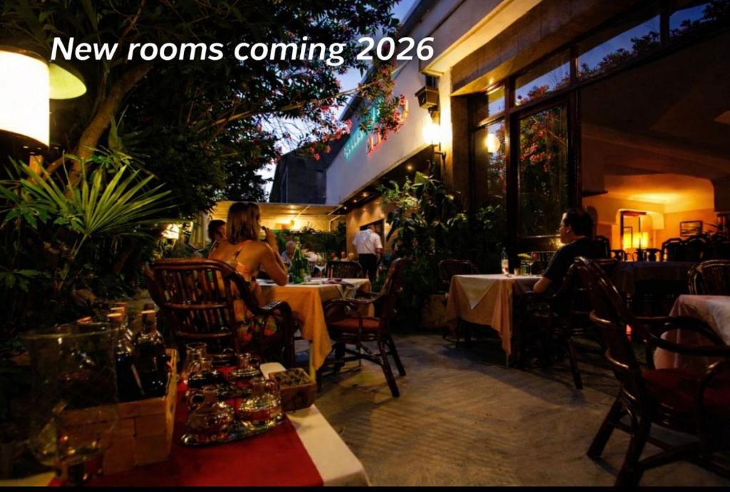 a group of people sitting at tables in a restaurant at Rubin Kitchen&Wine Rooms in Crikvenica