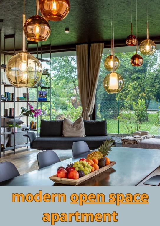 a modern open space apartment with a tray of fruit on a table at Rosso di sera -Vicenza Elite in Thiene